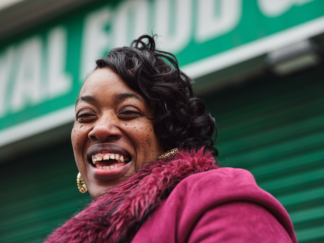 Women in plum-coloured coat smiling